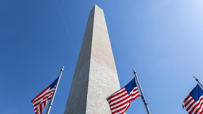 FILE - U.S. flags fly next to the Washington Monument on the National Mall in Washington on...
